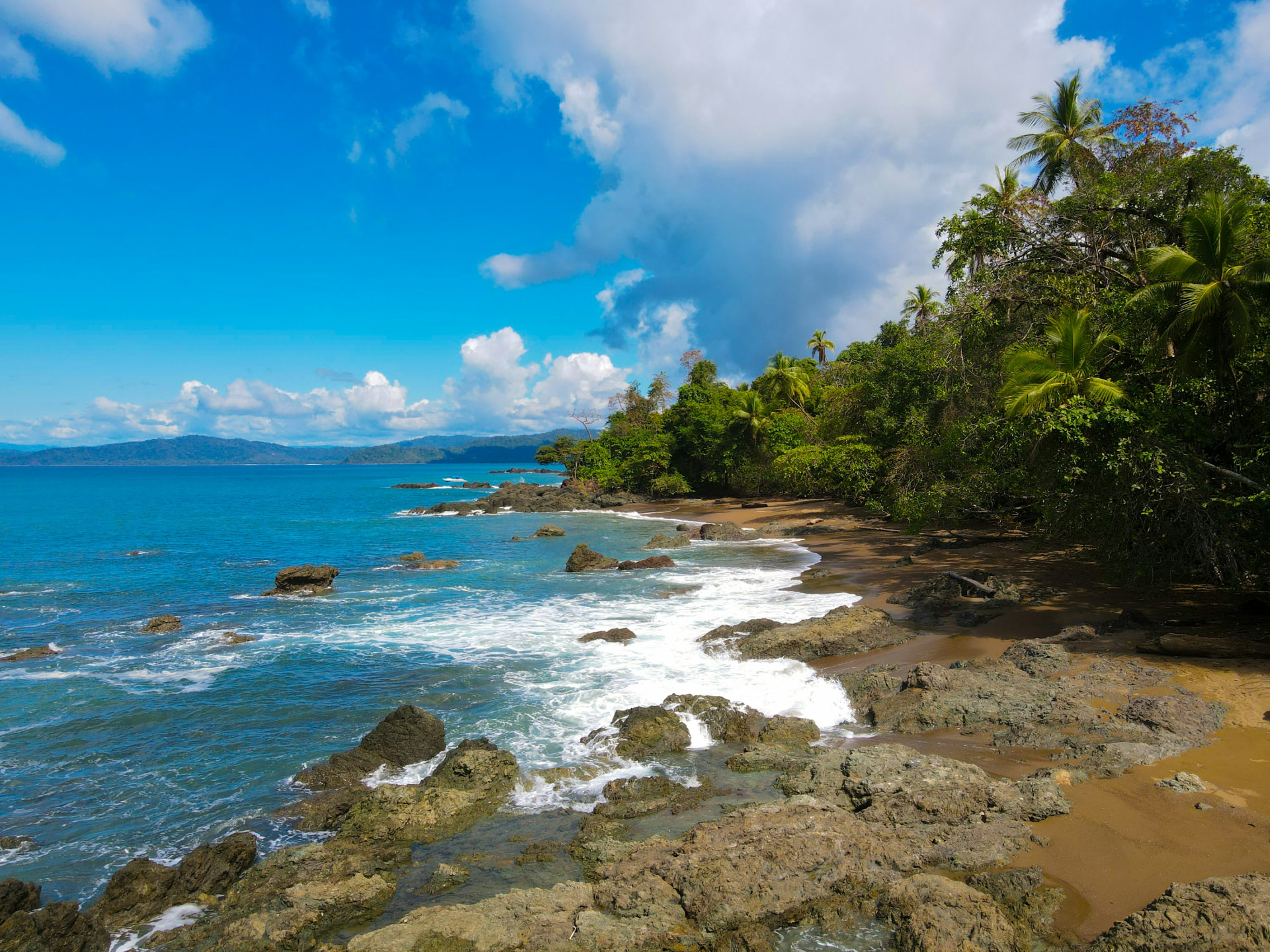 Rocky shoreline with waves breaking on the Ojochal coast, Costa Rica