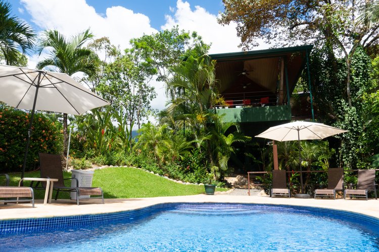 Pool surrounded by tropical gardens at Arbol Verde, Ojochal